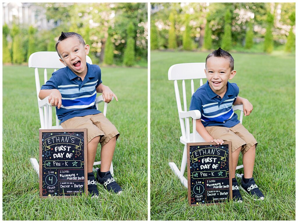 Ethan sitting on a white chair outdoors, with a green garden in the background. He's holding the same chalkboard sign from earlier. Photo taken in Westport, MA by family photographer Lorie-Lyn Photography. Watch Me Grow Session